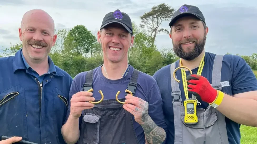 Alan Daniels, Andy Crammond and Gary Robertson holding the three Bronze Age gold torcs found near Carlisle